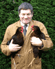 Image of Reg holding two chickens.