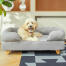 Chien assis sur Topology lit pour chien avec traversin et pieds en bois