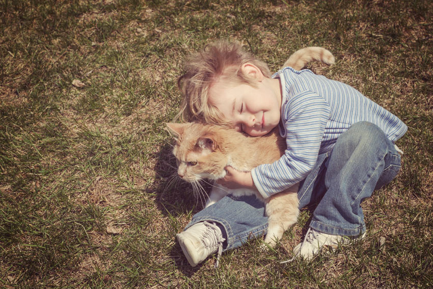 A young boy cuddling his new furry friend